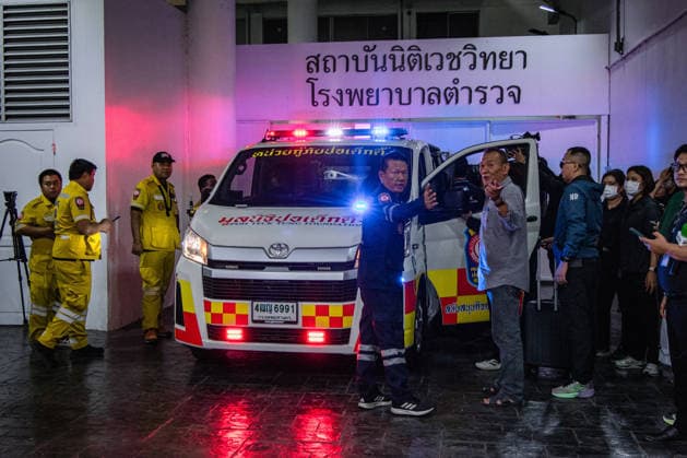 Relatives gather to claim bodies after Bangkok pub fire BANGKOK, THAILAND - JULY 13: Ambulance bring the coffins as relatives of the victims of a deadly pub fire arrive at the Institute of Forensic Medicine at the Police Hospital to claim the bodies in Bangkok, Thailand on July 13, 2026. The blaze at The Rong Beer Na Lat Phrao pub resulted in at least 27 deaths and left 63 others injured, including 22 in critical condition, making it one of the deadliest incidents in the popular tourist destination. Wissarut Weerasopon Anadolu Bangkok Thailand. Editorial use only. Please get in touch for any other usage.  Copyright: x2026xAnadoluxWissarutxWeerasoponx