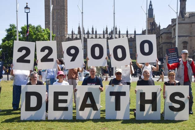 July 13, 2026, London, England, United Kingdom: Activists stage a protest in Parliament Square against the US-UK drug deal. An analysis has suggested that the trade deal could lead to 229,000 excess deaths in England as a result of diverting billions of pounds from essential NHS services to pay for new medicines. London United Kingdom - ZUMAv130 20260713_zip_v130_001 Copyright: xVukxValcicx