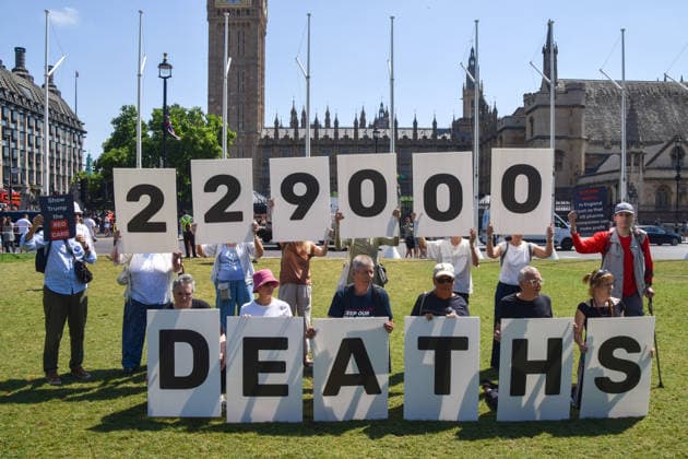 July 13, 2026, London, England, United Kingdom: Activists stage a protest in Parliament Square against the US-UK drug deal. An analysis has suggested that the trade deal could lead to 229,000 excess deaths in England as a result of diverting billions of pounds from essential NHS services to pay for new medicines. London United Kingdom - ZUMAv130 20260713_zip_v130_011 Copyright: xVukxValcicx