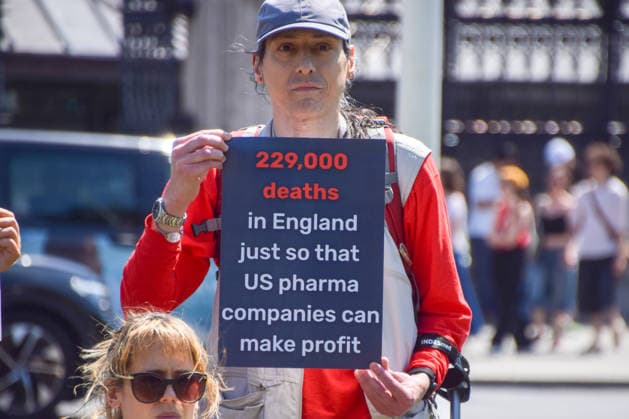 July 13, 2026, London, England, United Kingdom: Activists stage a protest in Parliament Square against the US-UK drug deal. An analysis has suggested that the trade deal could lead to 229,000 excess deaths in England as a result of diverting billions of pounds from essential NHS services to pay for new medicines. London United Kingdom  - ZUMAv130 20260713_zip_v130_010 Copyright: xVukxValcicx