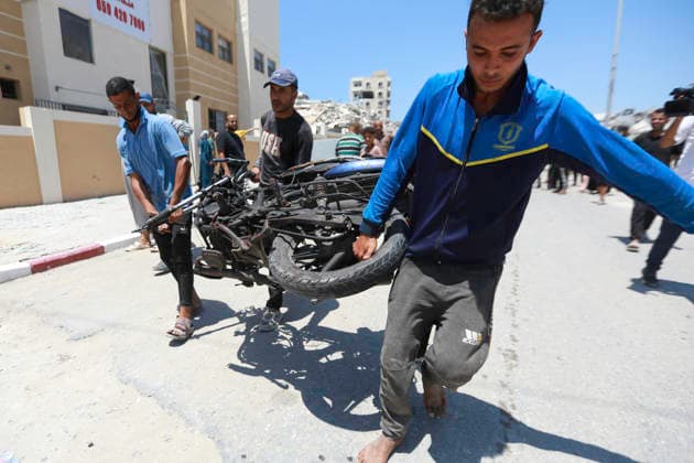 July 13, 2026, Gaza City, Gaza Strip, Palestinian Territory: Palestinians gather at the scene after a motorcycle was struck in western Gaza City. According to medical sources, at least one person was killed in the incident. Emergency teams transferred the victim to a nearby medical facility as authorities assessed the aftermath of the strike. Gaza City Palestinian Territory  - ZUMAz119 20260713_zip_z119_004 Copyright: xSalahxHashemx
