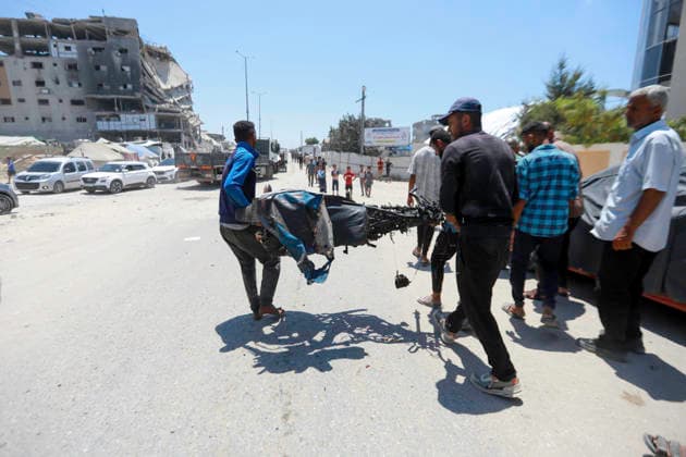 July 13, 2026, Gaza City, Gaza Strip, Palestinian Territory: Palestinians gather at the scene after a motorcycle was struck in western Gaza City. According to medical sources, at least one person was killed in the incident. Emergency teams transferred the victim to a nearby medical facility as authorities assessed the aftermath of the strike. Gaza City Palestinian Territory  - ZUMAz119 20260713_zip_z119_003 Copyright: xSalahxHashemx