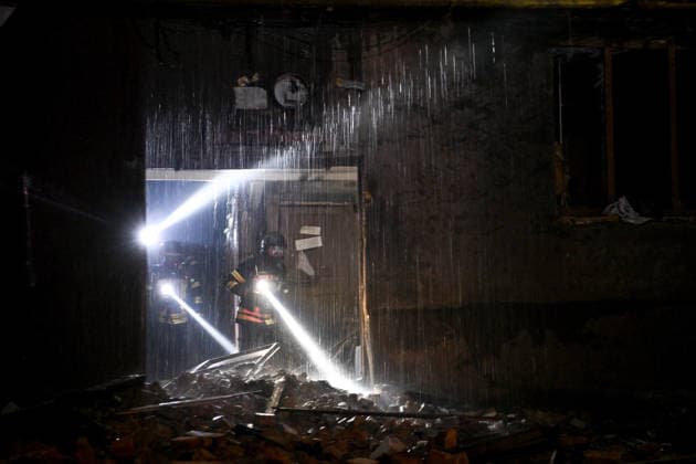 RECORD DATE NOT STATED Rescue workers carrying flashlights inspect a building flooded during firefighting efforts after it was damaged in a nighttime Russian drone attack in Zaporizhzhia, Ukraine, on July 12, 2026. Six people, including a 15-year-old boy, were injured in the attack(Photo by Dmytro Smolienko Ukrinform) Nighttime Russian drone strike hits Zaporizhzhia  Copyright: xDmytroxSmolienkox