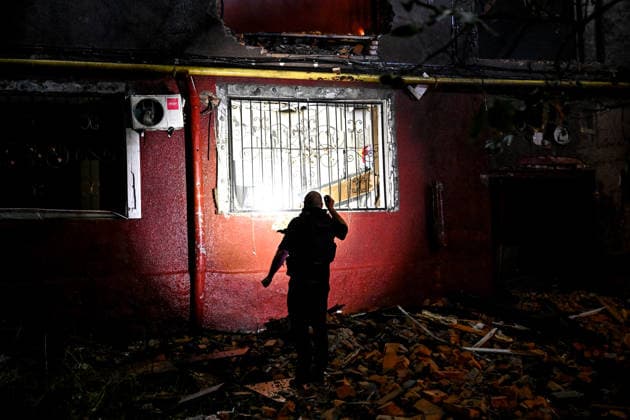 RECORD DATE NOT STATED A man carrying a flashlight inspects a building during emergency response efforts following a nighttime Russian drone attack in Zaporizhzhia, Ukraine, on July 12, 2026. Six people, including a 15-year-old boy, were injured in the attack (Photo by Dmytro Smolienko Ukrinform) Nighttime Russian drone strike hits Zaporizhzhia  Copyright: xDmytroxSmolienkox