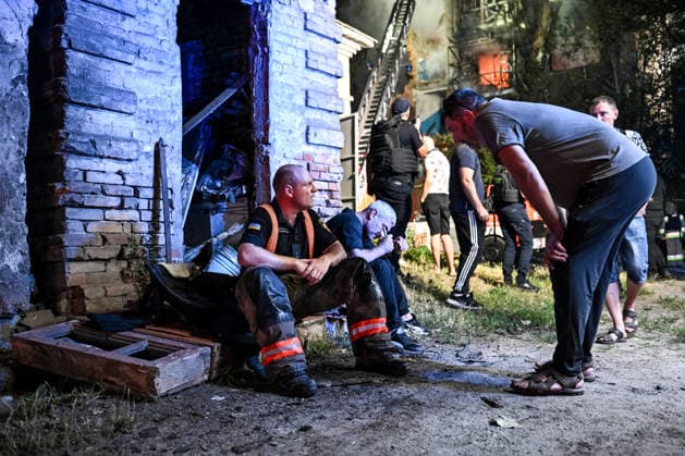 RECORD DATE NOT STATED A man talks to a firefighter with the State Emergency Service of Ukraine during emergency response efforts following a nighttime Russian drone attack in Zaporizhzhia, Ukraine, on July 12, 2026. Six people, including a 15-year-old boy, were injured in the attack (Photo by Dmytro Smolienko Ukrinform) Nighttime Russian drone strike hits Zaporizhzhia  Copyright: xDmytroxSmolienkox