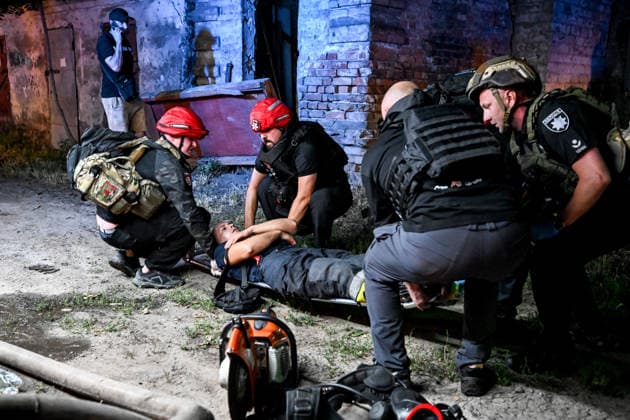 RECORD DATE NOT STATED Officers of the National Police of Ukraine and paramedics place an injured firefighter onto a stretcher during emergency response efforts following a nighttime Russian drone attack in Zaporizhzhia, Ukraine, on July 12, 2026. Six people, including a 15-year-old boy, were injured in the attack (Photo by Dmytro Smolienko Ukrinform) Nighttime Russian drone strike hits Zaporizhzhia  Copyright: xDmytroxSmolienkox