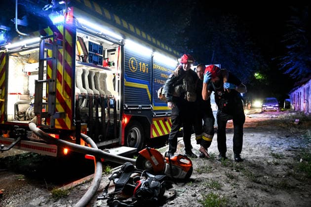 RECORD DATE NOT STATED An officer of the National Police of Ukraine and a paramedic assist an injured firefighter during emergency response efforts following a nighttime Russian drone attack in Zaporizhzhia, Ukraine, on July 12, 2026. Six people, including a 15-year-old boy, were injured in the attack (Photo by Dmytro Smolienko Ukrinform) Nighttime Russian drone strike hits Zaporizhzhia  Copyright: xDmytroxSmolienkox
