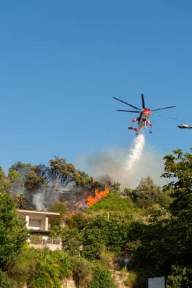 Wildfire erupts near Campi Flegrei volcanic area in Italy POZZUOLI, ITALY - JULY 13: An helicopter drops water over a wildfire on the outer edge of the Solfatara volcanic crater in the Campi Flegrei (Phlegraean Fields) volcanic region in Pozzuoli on July 13, 2026. The fire broke out in the undergrowth and quickly spread in the Pisciarelli area to several car dealerships, causing fuel tanks and tyres to explode. Eliano Imperato Anadolu Pozzuoli Italy. Editorial use only. Please get in touch for any other usage.  Copyright: x2026xAnadoluxElianoxImperatox