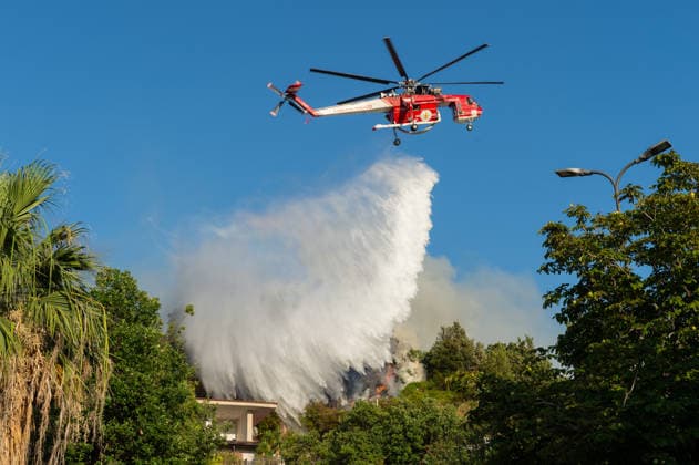 Wildfire erupts near Campi Flegrei volcanic area in Italy POZZUOLI, ITALY - JULY 13: An helicopter drops water over a wildfire on the outer edge of the Solfatara volcanic crater in the Campi Flegrei (Phlegraean Fields) volcanic region in Pozzuoli on July 13, 2026. The fire broke out in the undergrowth and quickly spread in the Pisciarelli area to several car dealerships, causing fuel tanks and tyres to explode. Eliano Imperato Anadolu Pozzuoli Italy. Editorial use only. Please get in touch for any other usage.  Copyright: x2026xAnadoluxElianoxImperatox