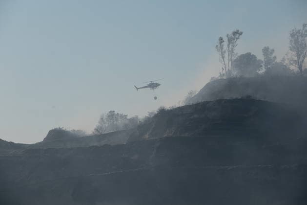 Wildfire erupts near Campi Flegrei volcanic area in Italy POZZUOLI, ITALY - JULY 13: An helicopter flights over a wildfire in the Pisciarelli area located on the outer edge of the Solfatara volcanic crater in the Campi Flegrei (Phlegraean Fields) volcanic region in Pozzuoli on July 13, 2026. The fire broke out in the undergrowth and quickly spread to several car dealerships, causing fuel tanks and tyres to explode. Eliano Imperato Anadolu Pozzuoli Italy. Editorial use only. Please get in touch for any other usage.  Copyright: x2026xAnadoluxElianoxImperatox