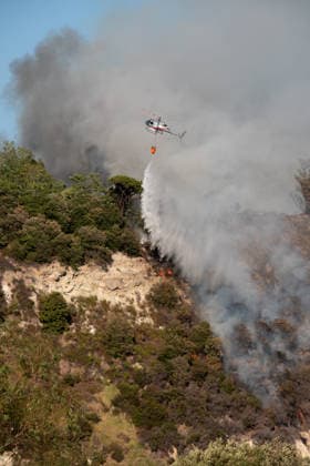 Wildfire erupts near Campi Flegrei volcanic area in Italy POZZUOLI, ITALY - JULY 13: An helicopter drops water over a wildfire in the Solfatara volcanic crater in the Campi Flegrei (Phlegraean Fields) volcanic region in Pozzuoli on July 13, 2026. The fire broke out in the undergrowth and quickly spread in the Pisciarelli area to several car dealerships, causing fuel tanks and tyres to explode. Eliano Imperato Anadolu Pozzuoli Italy. Editorial use only. Please get in touch for any other usage.  Copyright: x2026xAnadoluxElianoxImperatox
