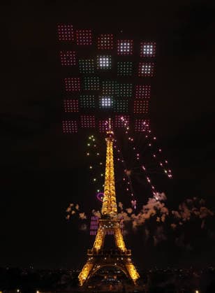Fireworks and drones light the Eiffel Tower during the Bastille Day celebrations in Paris, France, on Monday, July 13, 2026. The municipality brought the event a day earlier so as to dedicate entirely July 14, 2026 to a national tribute marking the 10th anniversary of the Nice attack when 86 people were killed.  PAR20260713102 MAYAxVIDON-WHITE