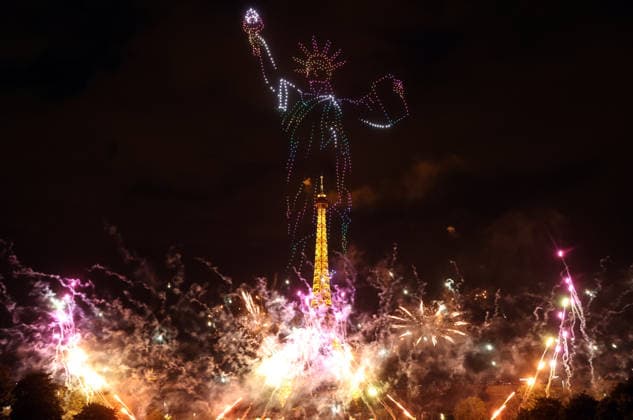 Fireworks and drones light the Eiffel Tower during the Bastille Day celebrations in Paris, France, on Monday, July 13, 2026. The municipality brought the event a day earlier so as to dedicate entirely July 14, 2026 to a national tribute marking the 10th anniversary of the Nice attack when 86 people were killed.  PAR20260713105 MAYAxVIDON-WHITE