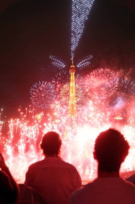 Fireworks and drones light the Eiffel Tower during the Bastille Day celebrations in Paris, France, on Monday, July 13, 2026. The municipality brought the event a day earlier so as to dedicate entirely July 14, 2026 to a national tribute marking the 10th anniversary of the Nice attack when 86 people were killed.  PAR20260713109 MAYAxVIDON-WHITE