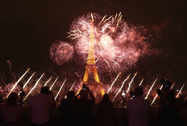 Fireworks and drones light the Eiffel Tower during the Bastille Day celebrations in Paris, France, on Monday, July 13, 2026. The municipality brought the event a day earlier so as to dedicate entirely July 14, 2026 to a national tribute marking the 10th anniversary of the Nice attack when 86 people were killed.  PAR20260713112 MAYAxVIDON-WHITE