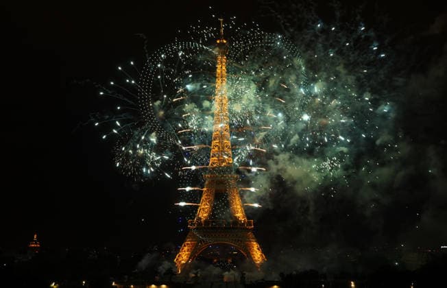 Fireworks and drones light the Eiffel Tower during the Bastille Day celebrations in Paris, France, on Monday, July 13, 2026. The municipality brought the event a day earlier so as to dedicate entirely July 14, 2026 to a national tribute marking the 10th anniversary of the Nice attack when 86 people were killed.  PAR20260713115 MAYAxVIDON-WHITE