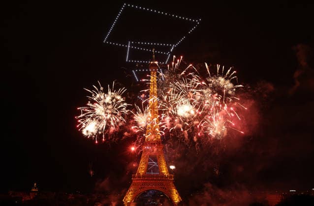 Fireworks and drones light the Eiffel Tower during the Bastille Day celebrations in Paris, France, on Monday, July 13, 2026. The municipality brought the event a day earlier so as to dedicate entirely July 14, 2026 to a national tribute marking the 10th anniversary of the Nice attack when 86 people were killed.  PAR20260713116 MAYAxVIDON-WHITE