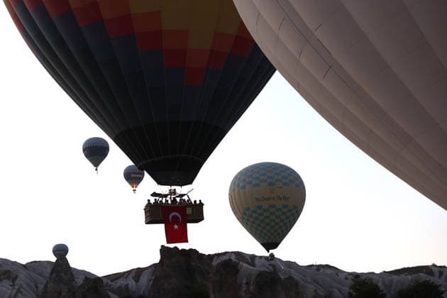 Cappadocia commemorates martyrs of 2016 defeated coup attempt NEVSEHIR, TURKIYE - JULY 14: Hot air balloons take off in Cappadocia carrying Turkish flags and banners featuring photographs of the 253 martyrs to commemorate July 15 Democracy and National Unity Day in Nevsehir, Turkiye on July 14, 2026. As part of the event organized by the Nevsehir Governorship, banners displaying Turkish flags and photographs of the martyrs were attached to the hot air balloons. Behcet Alkan Anadolu Nevsehir Turkey. Editorial use only. Please get in touch for any other usage.  Copyright: x2026xAnadoluxBehcetxAlkanx