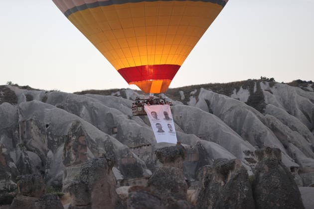 Cappadocia commemorates martyrs of 2016 defeated coup attempt NEVSEHIR, TURKIYE - JULY 14: Hot air balloons take off in Cappadocia carrying Turkish flags and banners featuring photographs of the 253 martyrs to commemorate July 15 Democracy and National Unity Day in Nevsehir, Turkiye on July 14, 2026. As part of the event organized by the Nevsehir Governorship, banners displaying Turkish flags and photographs of the martyrs were attached to the hot air balloons. Behcet Alkan Anadolu Nevsehir Turkey. Editorial use only. Please get in touch for any other usage.  Copyright: x2026xAnadoluxBehcetxAlkanx