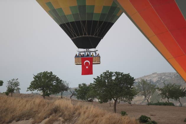 Cappadocia commemorates martyrs of 2016 defeated coup attempt NEVSEHIR, TURKIYE - JULY 14: Hot air balloons take off in Cappadocia carrying Turkish flags and banners featuring photographs of the 253 martyrs to commemorate July 15 Democracy and National Unity Day in Nevsehir, Turkiye on July 14, 2026. As part of the event organized by the Nevsehir Governorship, banners displaying Turkish flags and photographs of the martyrs were attached to the hot air balloons. Behcet Alkan Anadolu Nevsehir Turkey. Editorial use only. Please get in touch for any other usage.  Copyright: x2026xAnadoluxBehcetxAlkanx