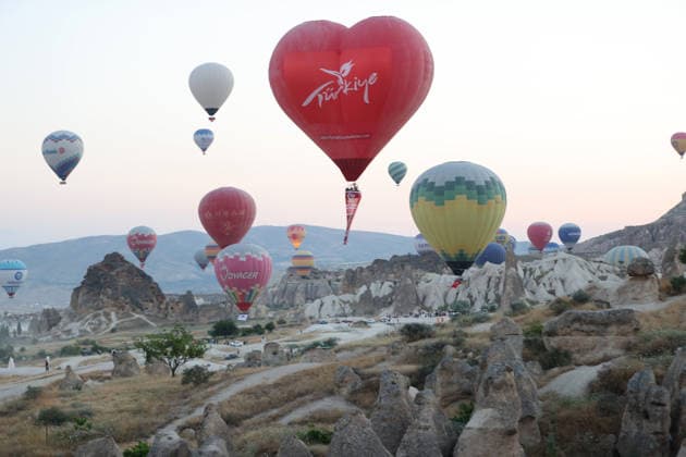 Cappadocia commemorates martyrs of 2016 defeated coup attempt NEVSEHIR, TURKIYE - JULY 14: Hot air balloons take off in Cappadocia carrying Turkish flags and banners featuring photographs of the 253 martyrs to commemorate July 15 Democracy and National Unity Day in Nevsehir, Turkiye on July 14, 2026. As part of the event organized by the Nevsehir Governorship, banners displaying Turkish flags and photographs of the martyrs were attached to the hot air balloons. Behcet Alkan Anadolu Nevsehir Turkey. Editorial use only. Please get in touch for any other usage.  Copyright: x2026xAnadoluxBehcetxAlkanx