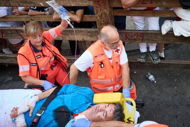 Eighth and final bull run of the 2026 San Fermin Festival, featuring bulls from the Jandilla ranch; Red Cross volunteers treat an injured person from the final bull run of the 2026 San Fermin Festival, on July 14, 2026, in Pamplona, Navarre, Spain. Bulls from the Jandilla ranch bring the San Fermín festivities to a close with their participation in the eighth running of the festival. Spain  Copyright: xEduardoxSanzx 7663057
