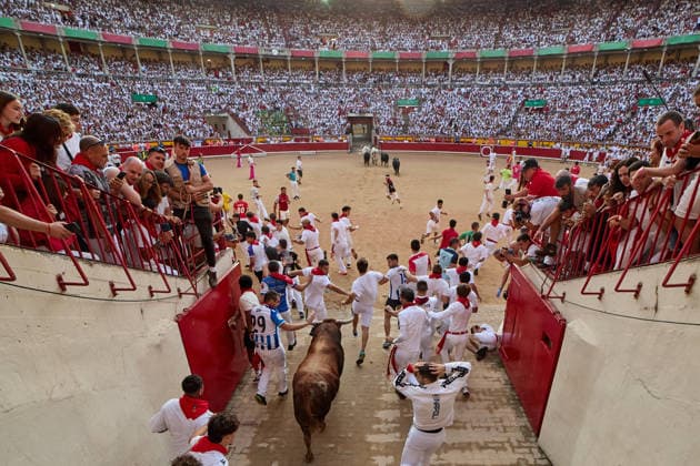 July 14, 2026, Pamplona, Navarre, Spain: People take part in the traditional encierro (bull-run) of the San Fermin Festival in Pamplona, Spain on July 14, 2026. The bull-running fiesta is held annually from 06 to 14 July in commemoration of the city s patron saint. Visitors from all over the world attend the festival. Many of them physically participate in the highlight event - the running of the bulls, or encierro - where they attempt to outrun the animals along a route through the narrow streets of Pamplona s old city. Pamplona Spain - ZUMAa206 20260714_zsp_a206_015 Copyright: xRubenxAlbarranx