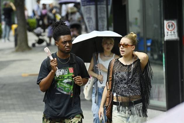 Extreme heat grips Tokyo as temperatures rise across eastern Japan TOKYO, JAPAN - JULY 14 : Pedestrians carry parasol and use portable cooling devices while walking along Takeshita Street in Tokyo s Harajuku district during hot weather in Tokyo, Japan, July 14, 2026. Temperatures in central Tokyo were forecast to reach 34 degrees Celsius. David Mareuil Anadolu Tokyo Japan. Editorial use only. Please get in touch for any other usage.  Copyright: x2026xAnadoluxDavidxMareuilx