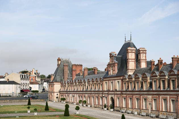 (260714) -- SEINE-ET-MARNE, July 14, 2026 -- This photo taken on July 14, 2026 shows the Palace of Fontainebleau in Seine-et-Marne, France, with smoke from a wildfire rising in the distance. French police have detained 59 people across the country in connection with wildfires, including two suspects linked to the blaze in the Fontainebleau forest in Seine-et-Marne department, southeast of Paris, French Interior Minister Laurent Nunez said on Monday. The wildfire in the Fontainebleau forest broke out on Sunday evening and continued to spread on Monday. ) FRANCE-SEINE-ET-MARNE-FONTAINEBLEAU-WILDFIRE WuxHuiwo 
