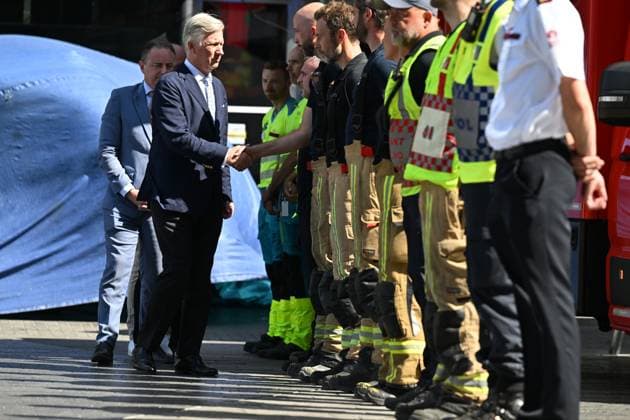 Prime Minister Bart de Wever, King Philippe - Filip of Belgium and pictured at the scene of a fire at the OXY building at place De Brouckere, in Brussels, Tuesday 14 July 2026s. The Brussels Labour Inspectorate confirms several bodies were found in the lift shafts, 6 people are still missing. The fire broke out on the second floor of the building that is currently being renovated.  EMILExWINDAL 181130133