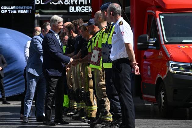 Prime Minister Bart de Wever, King Philippe - Filip of Belgium and pictured at the scene of a fire at the OXY building at place De Brouckere, in Brussels, Tuesday 14 July 2026s. The Brussels Labour Inspectorate confirms several bodies were found in the lift shafts, 6 people are still missing. The fire broke out on the second floor of the building that is currently being renovated.  EMILExWINDAL 181130175