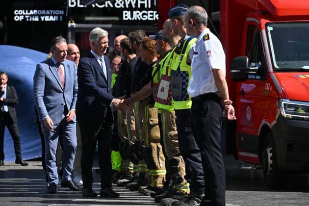 Prime Minister Bart de Wever, King Philippe - Filip of Belgium and pictured at the scene of a fire at the OXY building at place De Brouckere, in Brussels, Tuesday 14 July 2026s. The Brussels Labour Inspectorate confirms several bodies were found in the lift shafts, 6 people are still missing. The fire broke out on the second floor of the building that is currently being renovated.  EMILExWINDAL 181130188