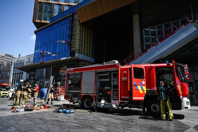 (260714) -- BRUSSELS, July 14, 2026 -- Firefighters arrive at the fire site of the Oxy building on De Brouckere Square, Brussels, Belgium, July 14, 2026. Multiple people have died on Tuesday in a fire at the well-known Oxy building on De Brouckere Square, in the center of Brussels. According to local media, 6 people are still missing. The fire brigade has deployed en masse for a major search and rescue operation. ) (SpotNews) BELGIUM-BRUSSELS-BUILDING-FIRE PengxZiyang 