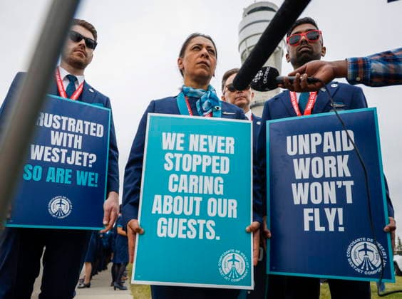 July 14, 2026, Calgary, Ab, CANADA: Alia Hussain, centre, President of CUPE Local 8125, speaks to the media as WestJet flight attendants hold a Day of Action while union members vote on a possible strike in Calgary, Tuesday, July 14, 2026. Calgary CANADA  - ZUMAc35_ 20260714_zaf_c35_046 Copyright: xJeffxMcintoshx