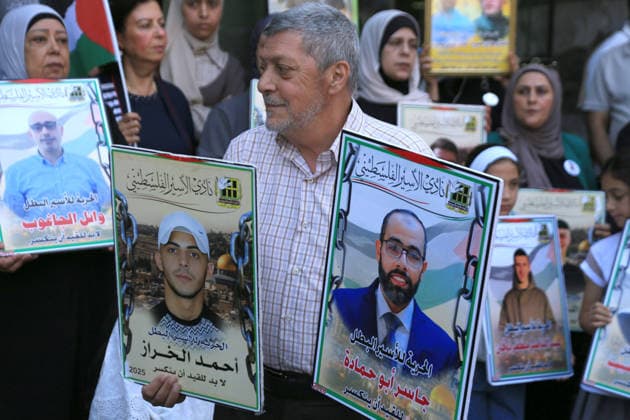 July 14, 2026, Nablus, Palestine: A Palestinian father holds portraits of his imprisoned sons during a demonstration in downtown Nablus in the West Bank, demanding their release from Israeli prisons. Released prisoners said that prison guards fired rubber bullets at the Palestinian leader Marwan Barghouti inside his cell. Barghouti is serving five life sentences plus forty years, and has spent more than twenty-four years in Israeli prison. Nablus Palestine - ZUMAs197 20260714_aaa_s197_096 Copyright: xNasserxishatyehx