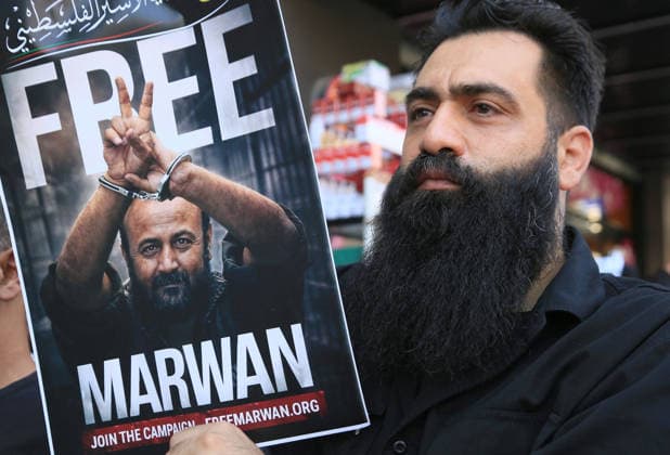 July 14, 2026, Nablus, Palestine: A Palestinian man holds up a portrait of leader Marwan Barghouti during a demonstration in downtown Nablus in the West Bank, demanding his release from Israeli prisons. Released prisoners said that prison guards fired rubber bullets at the Palestinian leader Marwan Barghouti inside his cell. Barghouti is serving five life sentences plus forty years, and has spent more than twenty-four years in Israeli prison. Nablus Palestine - ZUMAs197 20260714_aaa_s197_097 Copyright: xNasserxishatyehx