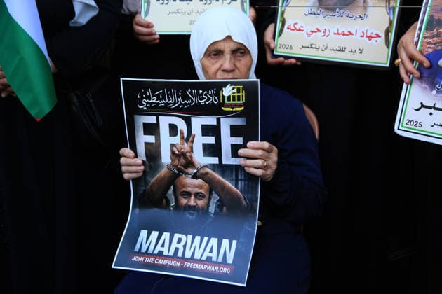 July 14, 2026, Nablus, Palestine: An elderly Palestinian woman holds up a poster of leader Marwan Barghouti, during a demonstration in downtown Nablus in the West Bank, demanding his release from Israeli prison. Released prisoners said that prison guards fired rubber bullets at the Palestinian leader Marwan Barghouti inside his cell. Barghouti is serving five life sentences plus forty years, and has spent more than twenty-four years in Israeli prison. Nablus Palestine - ZUMAs197 20260714_aaa_s197_099 Copyright: xNasserxishatyehx