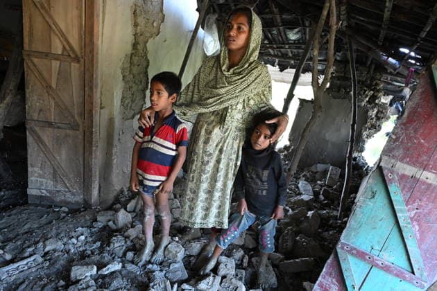 July 14, 2026, Banshkhali, Chattogram, Bangladesh: A woman and two children stand among collapsed walls and debris inside their flood-damaged home after floodwaters receded. Severe flooding across Chattogram Division has killed at least 54 and affected or displaced more than 1 million people across the country according to thre UN. Banshkhali Bangladesh - ZUMAh178 20260714_zip_h178_007 Copyright: xMuhammadxAmdadxHossainx