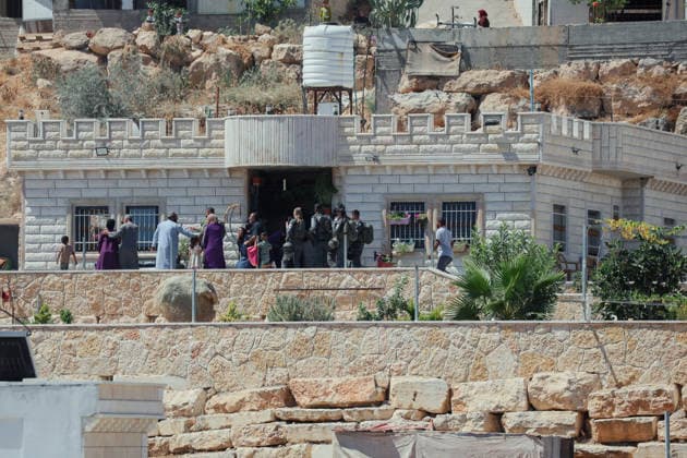 Hebron West Bank Home Demolition Israeli forces gather outside a Palestinian home in Al-Deirat, south of Hebron, occupied West Bank on July 14, 2026. Israeli forces demolish the home of Osama Masaaf on the grounds that it lacked an Israeli-issued building permit, displacing a Palestinian family of eight. Hebron West Bank Palestinian Territories Copyright: xMosabxShawerx