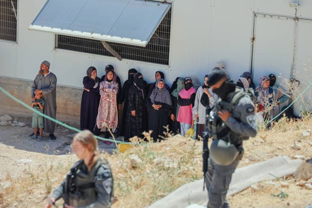 Hebron West Bank Home Demolition Palestinian residents watch Israeli forces during a home demolition operation in Al-Deirat, south of Hebron, occupied West Bank on July 14, 2026. Israeli forces demolish the home of Osama Masaaf on the grounds that it lacked an Israeli-issued building permit, displacing a Palestinian family of eight. Hebron West Bank Palestinian Territories Copyright: xMosabxShawerx
