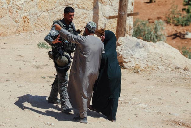 Hebron West Bank Home Demolition A Palestinian man and woman speak with an Israeli security officer during a home demolition operation in Al-Deirat, south of Hebron, occupied West Bank on July 14, 2026. Israeli forces demolish the home of Osama Masaaf on the grounds that it lacked an Israeli-issued building permit, displacing a Palestinian family of eight. Hebron West Bank Palestinian Territories Copyright: xMosabxShawerx