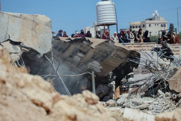 Hebron West Bank Home Demolition Palestinian residents watch as the home of Osama Masaaf s family is demolished in Al-Deirat, south of Hebron, occupied West Bank on July 14, 2026. Israeli forces demolish the house on the grounds that it lacked an Israeli-issued building permit, displacing the family of eight. Hebron West Bank Palestinian Territories Copyright: xMosabxShawerx
