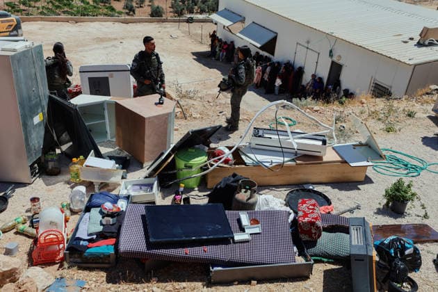 Hebron West Bank Home Demolition Household belongings lie outside the home of Osama Masaaf s family as Palestinian residents and Israeli forces gather during a demolition operation in Al-Deirat, south of Hebron, occupied West Bank on July 14, 2026. Israeli forces demolish the house on the grounds that it lacked an Israeli-issued building permit, displacing the family of eight. Hebron West Bank Palestinian Territories Copyright: xMosabxShawerx