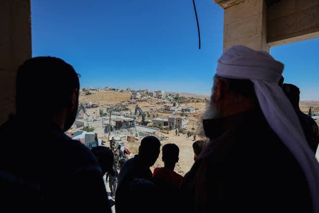 Hebron West Bank Home Demolition Palestinian residents watch as the home of Osama Masaaf s family is demolished in Al-Deirat, south of Hebron, occupied West Bank on July 14, 2026. Israeli forces demolish the house on the grounds that it lacked an Israeli-issued building permit, displacing the family of eight. Hebron West Bank Palestinian Territories Copyright: xMosabxShawerx