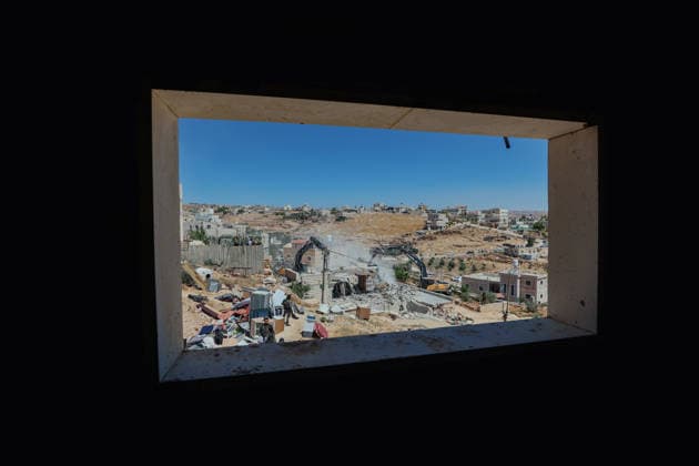 Hebron West Bank Home Demolition The demolition of the home of Osama Masaaf s family is viewed through a window in Al-Deirat, south of Hebron, occupied West Bank on July 14, 2026. Israeli forces demolish the house on the grounds that it lacked an Israeli-issued building permit, displacing the family of eight. Hebron West Bank Palestinian Territories Copyright: xMosabxShawerx