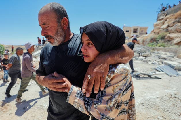 Hebron West Bank Home Demolition A Palestinian man comforts a woman near the rubble of the demolished home of Osama Masaaf s family in Al-Deirat, south of Hebron, occupied West Bank on July 14, 2026. Israeli forces demolish the house on the grounds that it lacked an Israeli-issued building permit, displacing the family of eight. Hebron West Bank Palestinian Territories Copyright: xMosabxShawerx