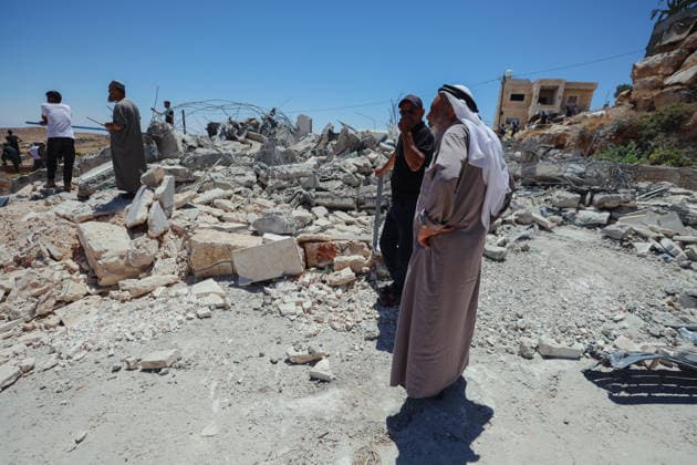 Hebron West Bank Home Demolition Palestinian residents stand near the rubble of the demolished home of Osama Masaaf s family in Al-Deirat, south of Hebron, occupied West Bank on July 14, 2026. Israeli forces demolish the house on the grounds that it lacked an Israeli-issued building permit, displacing the family of eight. Hebron West Bank Palestinian Territories Copyright: xMosabxShawerx