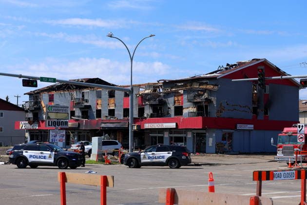 July 14, 2026, Edmonton, On, Canada: Edmonton police and fire investigators attend the scene of a structure fire at 132 Avenue and 82 Street in Edmonton, on Tuesday, July 14, 2026. Edmonton Canada  - ZUMAc35_ 20260714_zaf_c35_127 Copyright: xJamesxMaclennanx