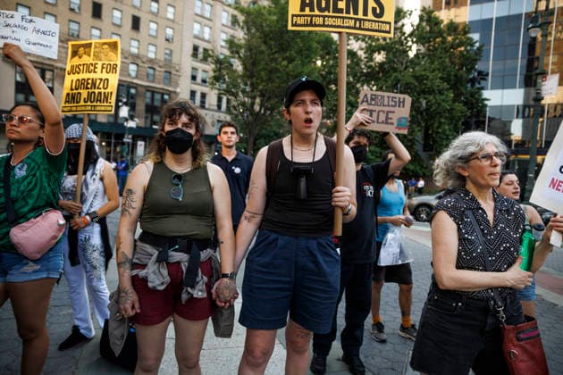 July 14, 2026, New York, New York, USA: A couple holds hands amongst rally-goers. Protesters gather and demand justice for Lorenzo Salgado Araujo, 52, a man shot and killed by Immigration and Customs Enforcement (ICE). Protesters call for a full investigation into the fatal shooting and demand an end to local collaboration with ICE. New York USA - ZUMAh182 20260714_znp_h182_005 Copyright: xMatthewxHoenx
