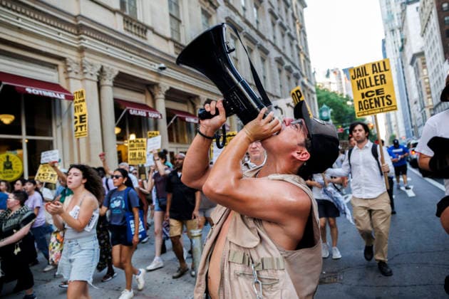 July 14, 2026, New York, New York, USA: A person is seen using a megaphone amongst rally-goers. Protesters gather and demand justice for Lorenzo Salgado Araujo, 52, a man shot and killed by Immigration and Customs Enforcement (ICE). Protesters call for a full investigation into the fatal shooting and demand an end to local collaboration with ICE. New York USA - ZUMAh182 20260714_znp_h182_008 Copyright: xMatthewxHoenx